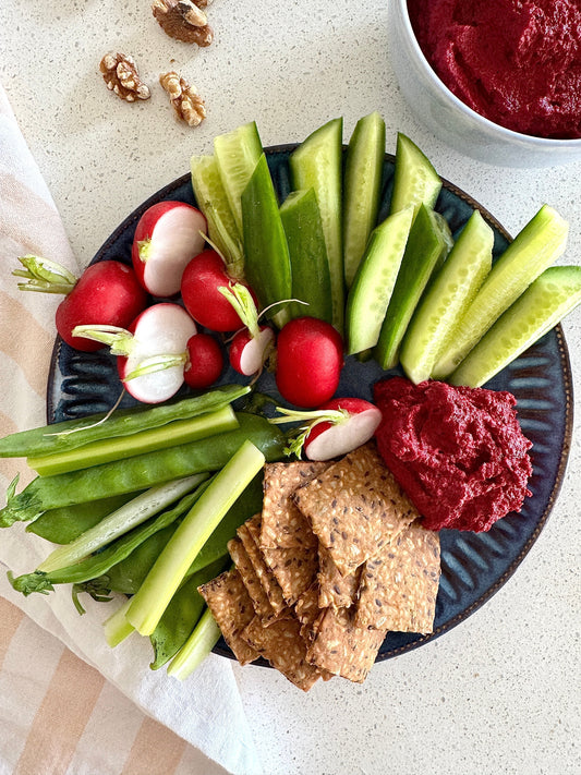 healthy snack: beetroot dip, veggie sticks and seed crackers