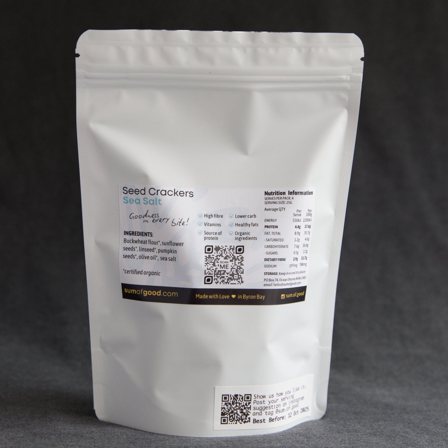Back of packaging of Sum of Good Seed Crackers with ingredients, nutritional information and QR code on a dark background