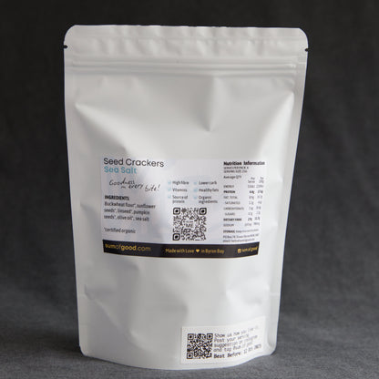 Back of packaging of Sum of Good Seed Crackers with ingredients, nutritional information and QR code on a dark background